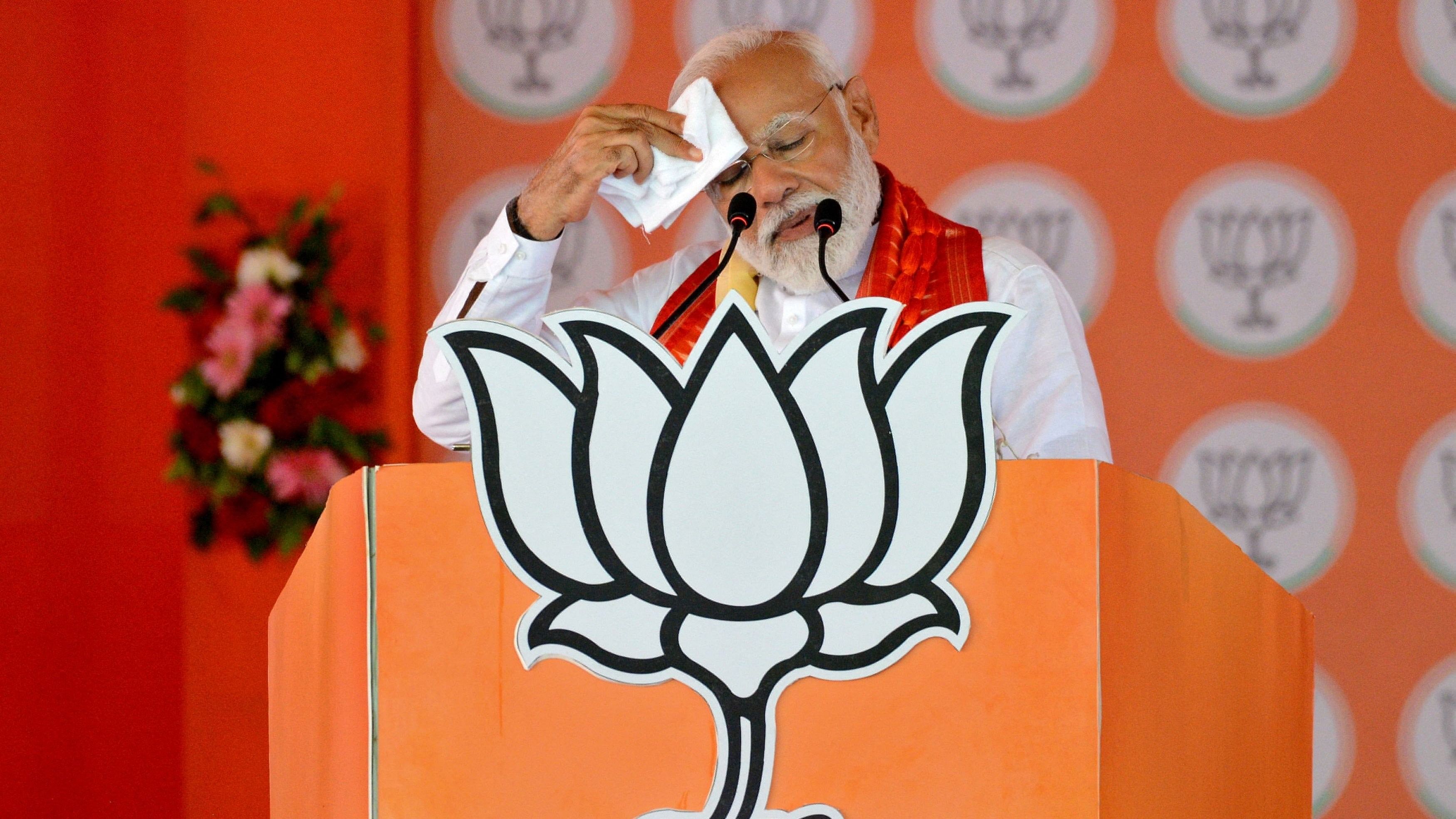 <div class="paragraphs"><p>Prime Minister Narendra Modi wipes sweat from his forehead as he addresses his supporters during an election campaign rally.</p></div>