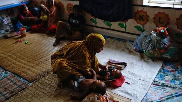 <div class="paragraphs"><p>A woman takes care of a four-day-old infant in a cyclone shelter before Cyclone Remal hits the country in the Shyamnagar area of Satkhira, Bangladesh, May 26, 2024.</p></div>