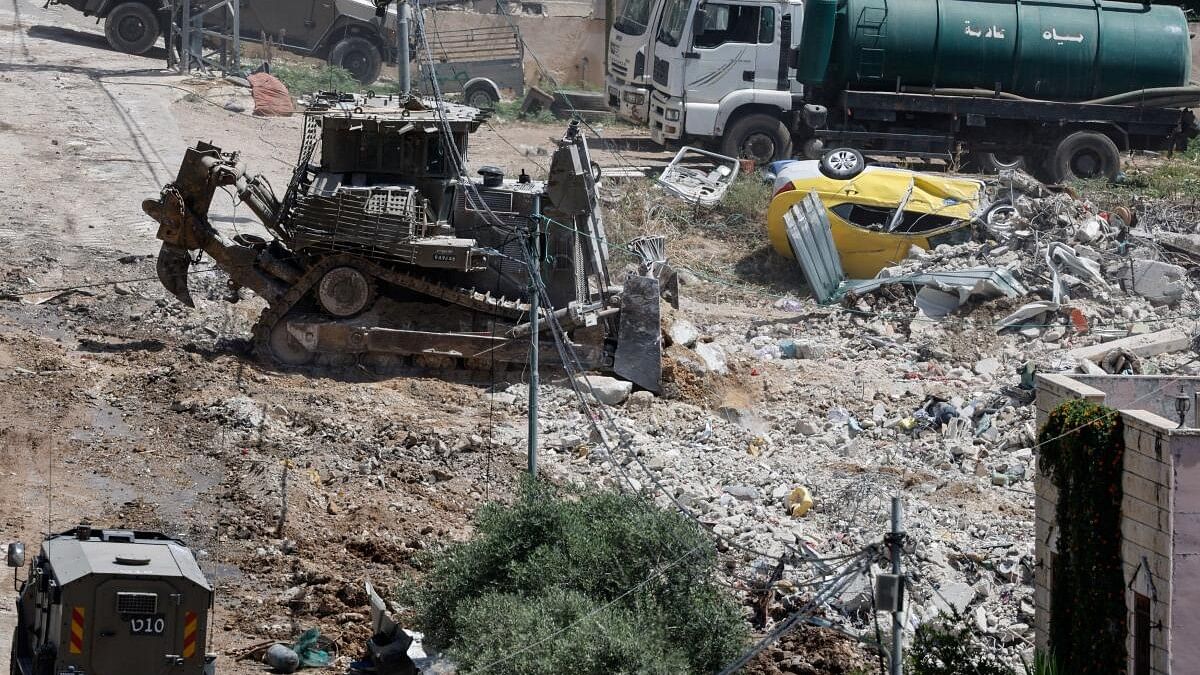 <div class="paragraphs"><p>A military bulldozer operates during an Israeli raid in Deir al-Ghusun, in the Israeli occupied West Bank.&nbsp;</p></div>
