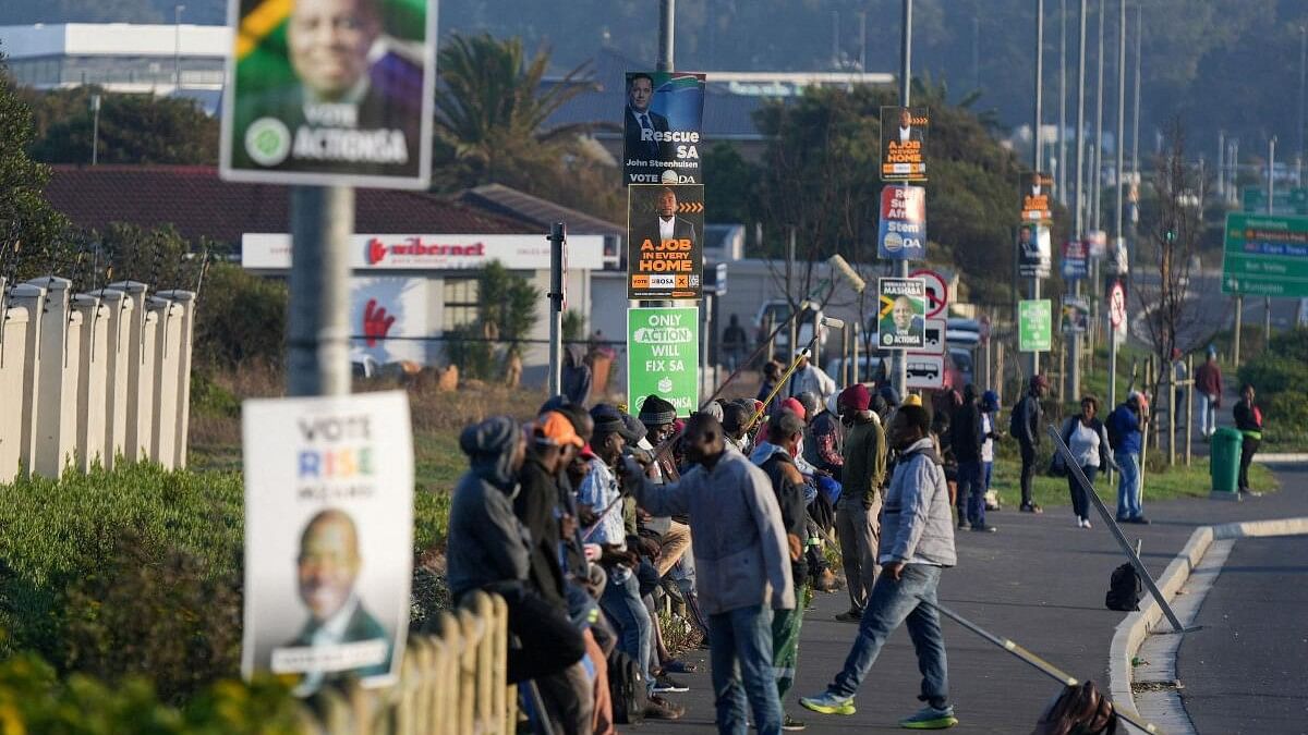 <div class="paragraphs"><p>Job seekers sit beneath campaign posters for the South African general elections, in Cape Town.&nbsp;</p></div>