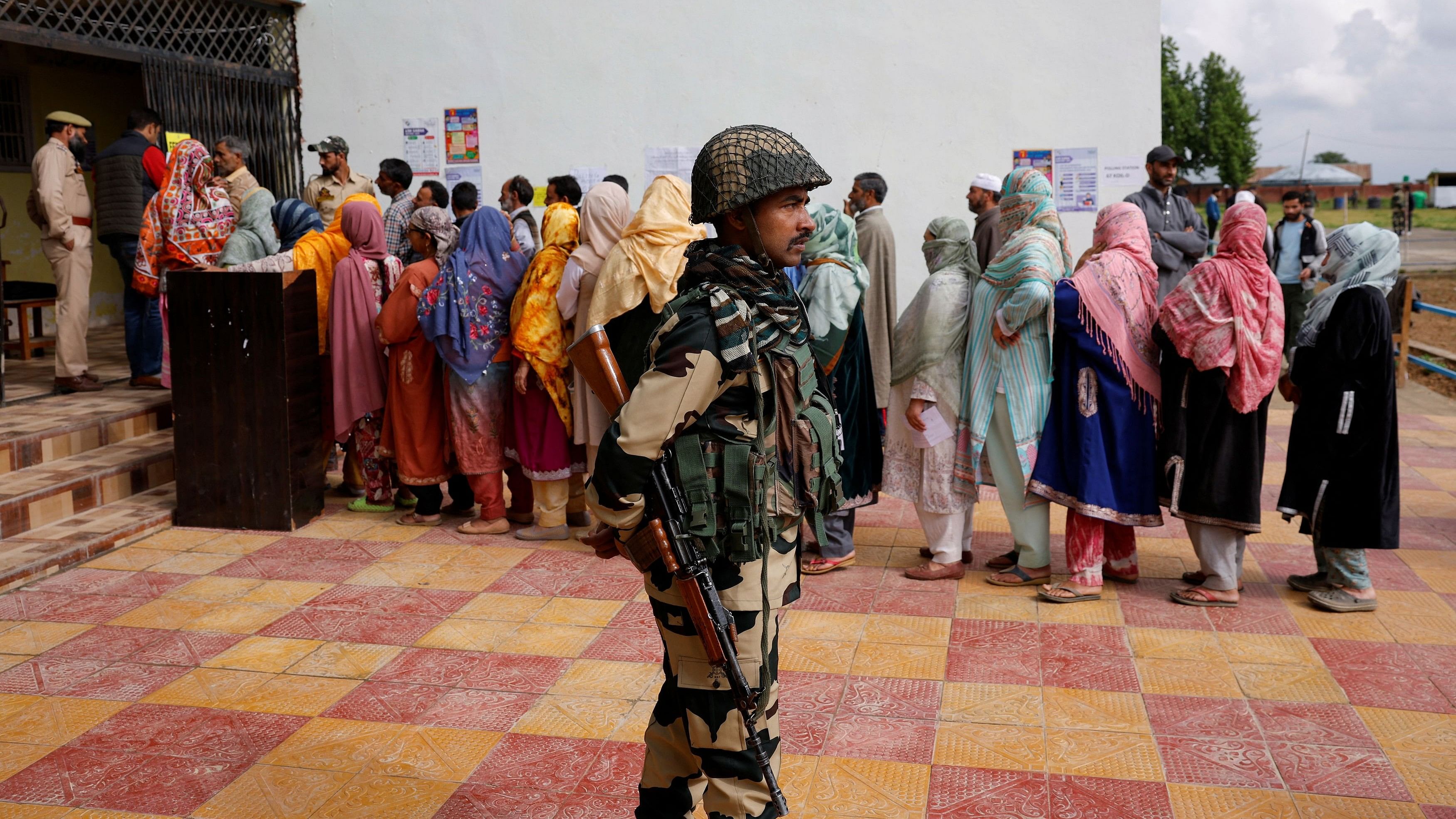 <div class="paragraphs"><p>A security personnel stands guard at a polling station, during the fourth general election phase, in south Kashmir's Pulwama district, on May 13, 2024.&nbsp;</p></div>