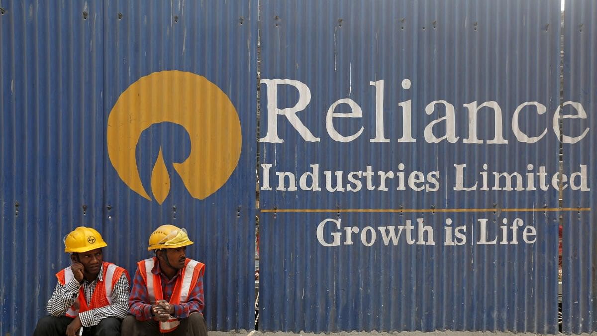 <div class="paragraphs"><p>Labourers rest in front of an advertisement for Reliance Industries Limited at a construction site in Mumbai, India.</p></div>