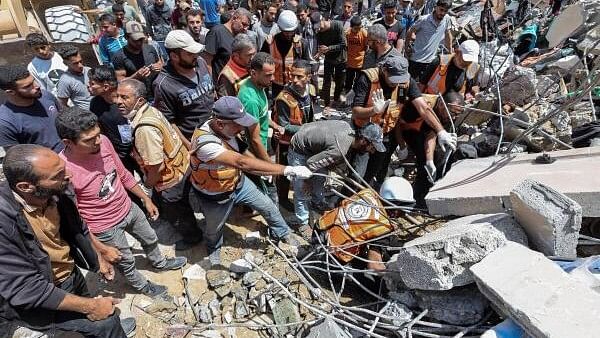 <div class="paragraphs"><p>People and rescuers work to recover the dead body of a Palestinian trapped under the rubble of a house hit in an Israeli strike, amid the ongoing conflict between Israel and the Palestinian Islamist group Hamas, in Nuseirat refugee camp in the central Gaza Strip, May 14, 2024.</p></div>