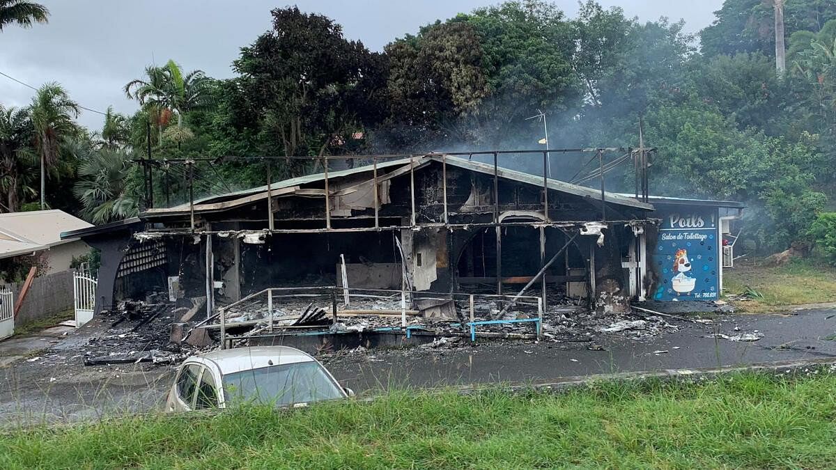 <div class="paragraphs"><p>A damaged building is seen as rioters protest against plans to allow more people to take part in local elections in the French-ruled territory, which indigenous Kanak protesters reject, in Noumea, New Caledonia.</p></div>