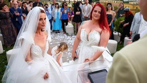 <div class="paragraphs"><p>Alba Ahmetaj and Edlira Mara look on during their wedding ceremony at the rooftop of the Mayor's office, even though no law allows same-sex marriage, in Tirana, Albania, May 19, 2024.</p></div>