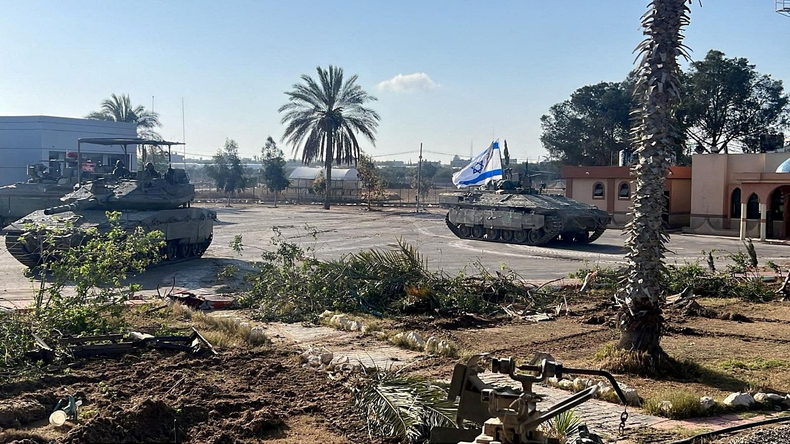 <div class="paragraphs"><p>Israeli military vehicles operate in the Gazan side of the Rafah Crossing.</p></div>