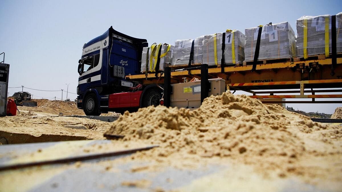 <div class="paragraphs"><p>A truck delivers humanitarian aid using the Trident Pier off the Gaza Strip near the Gaza coast on May 18, 2024. </p></div>