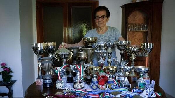 <div class="paragraphs"><p>Italian master runner Emma Maria Mazzenga, 90, poses for a picture with some of her trophies, at home in Padua, Italy.</p></div>