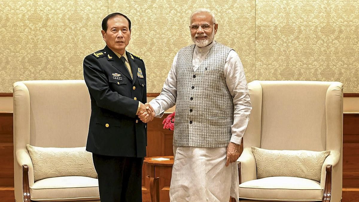 <div class="paragraphs"><p>(L) Defence Minister of China General Wei Fenghe shakes hand with&nbsp;Prime Minister Narendra Modi.</p></div>