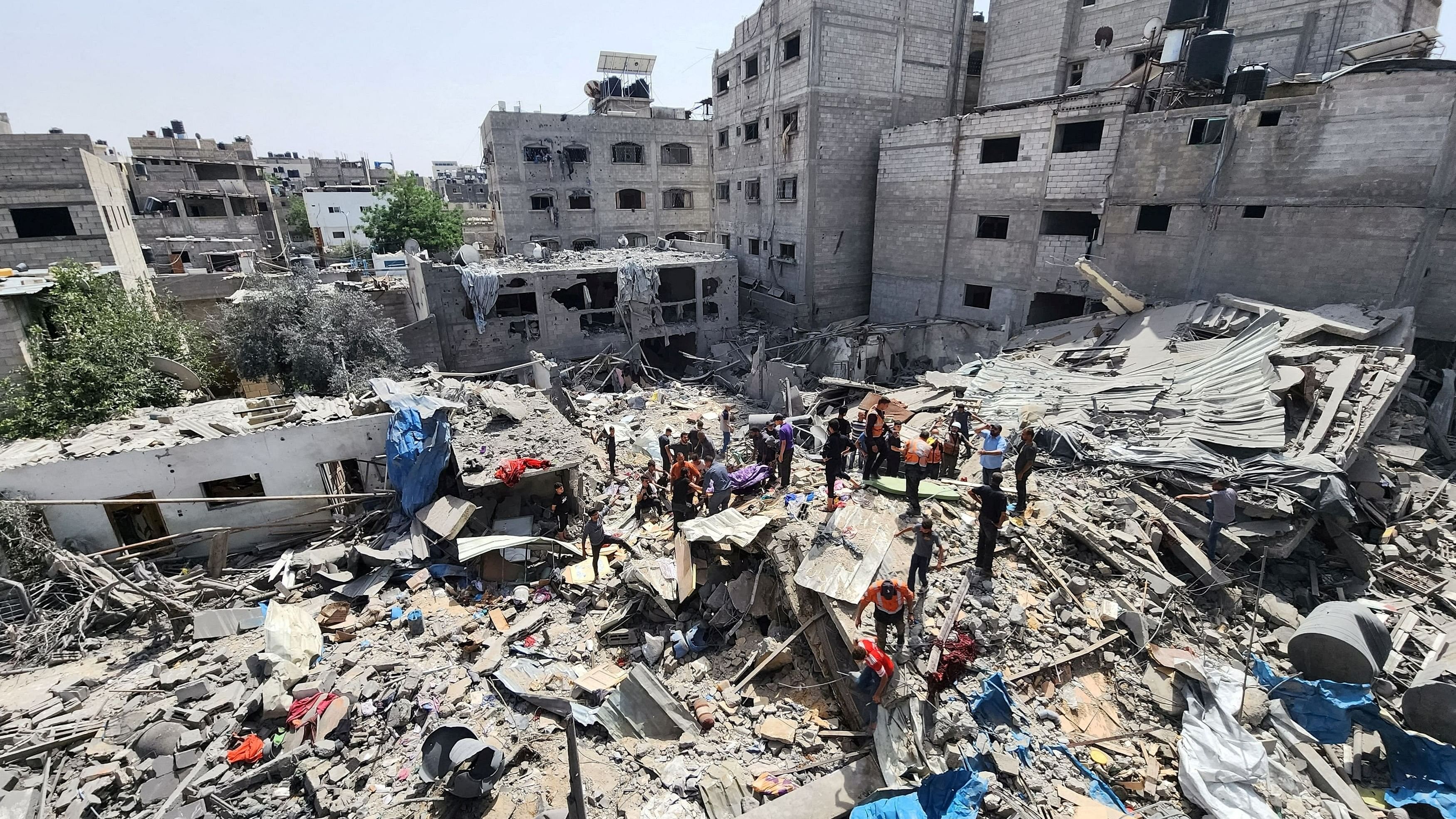 <div class="paragraphs"><p>Palestinians carry the body of a person killed in an Israeli strike on a house, amid the ongoing conflict between Israel and the Palestinian Islamist group Hamas, in Jabalia refugee camp in the northern Gaza Strip, May 18, 2024.</p></div>