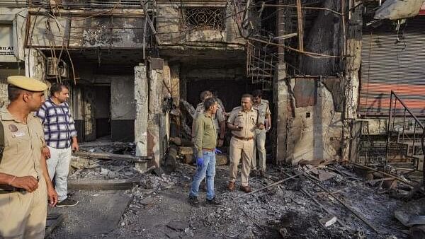 <div class="paragraphs"><p>A forensic expert collects samples from site of the fire at the New Born Baby Care Hospital, in east Delhi.</p></div>