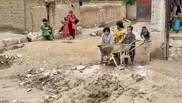 <div class="paragraphs"><p>Children look on, in the aftermath of floods following heavy rain, in Kar Kar village, Baghlan province, Afghanistan May 11, 2024.</p></div>