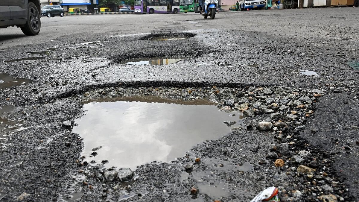 <div class="paragraphs"><p>Vehicles navigate on potholes at Banashankari in Bengaluru.</p></div>