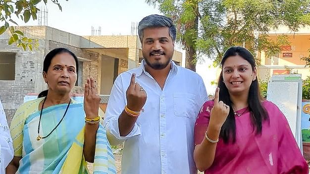 <div class="paragraphs"><p>Nationalist Congress Party (Sharadchandra Pawar) leader Rohit Pawar (C) with family members shows inked fingers after casting votes at a polling station during the 3rd phase of Lok Sabha polls, at Pimpli in Baramati.</p></div>