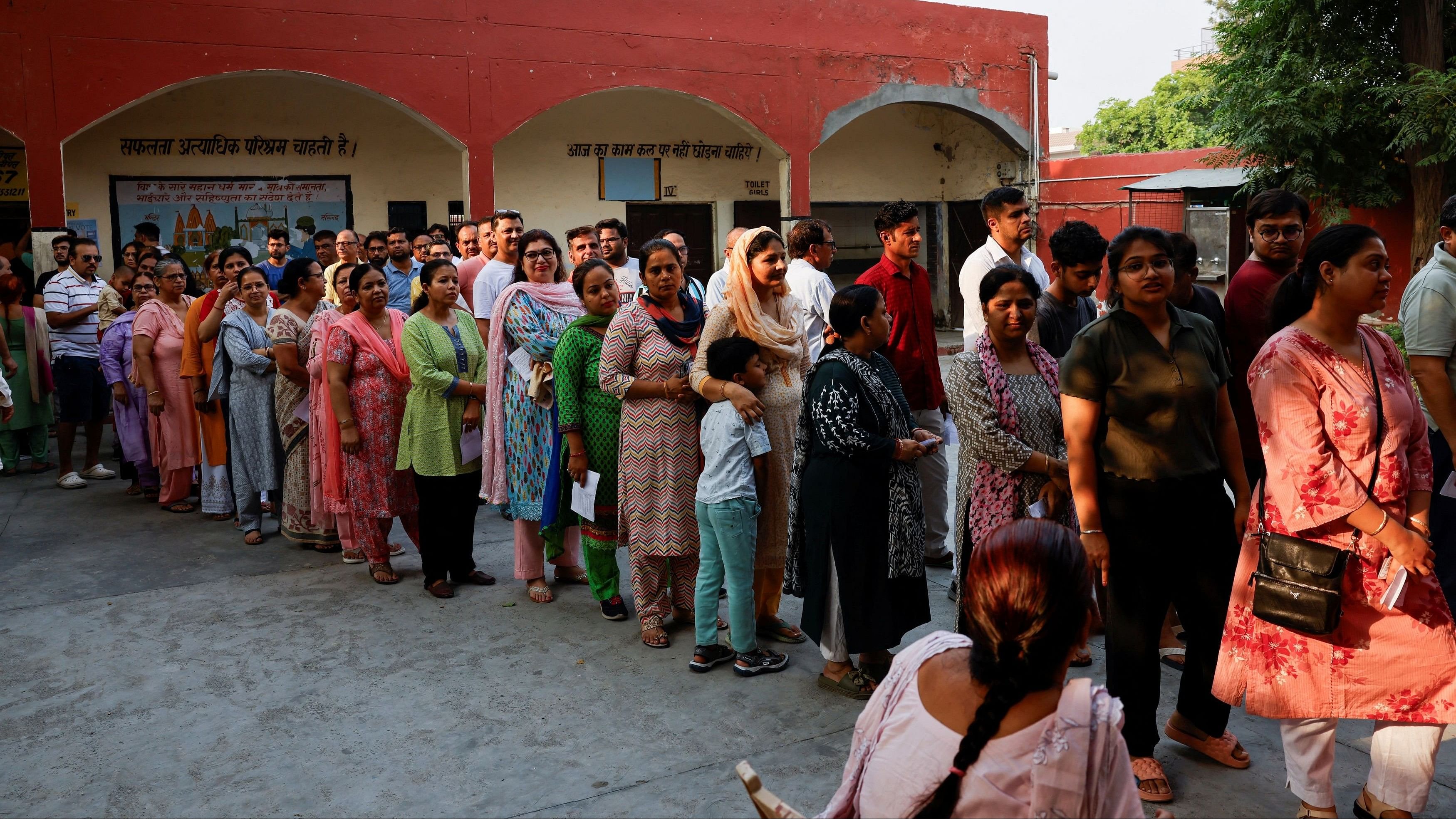 <div class="paragraphs"><p>Voters line up to cast their votes outside a polling station.</p></div>