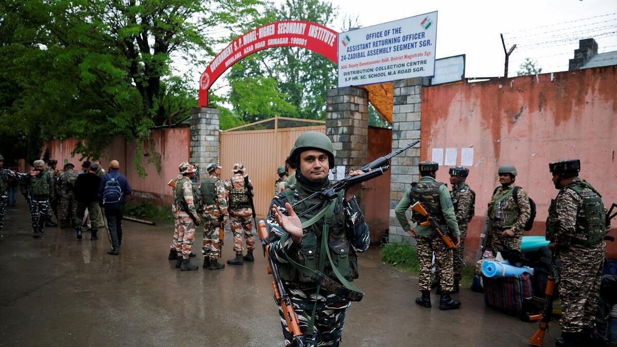 <div class="paragraphs"><p>Security personnel stand guard outisde a distribution centre ahead of the fourth phase of the general elections in Srinagar May 12.</p></div>