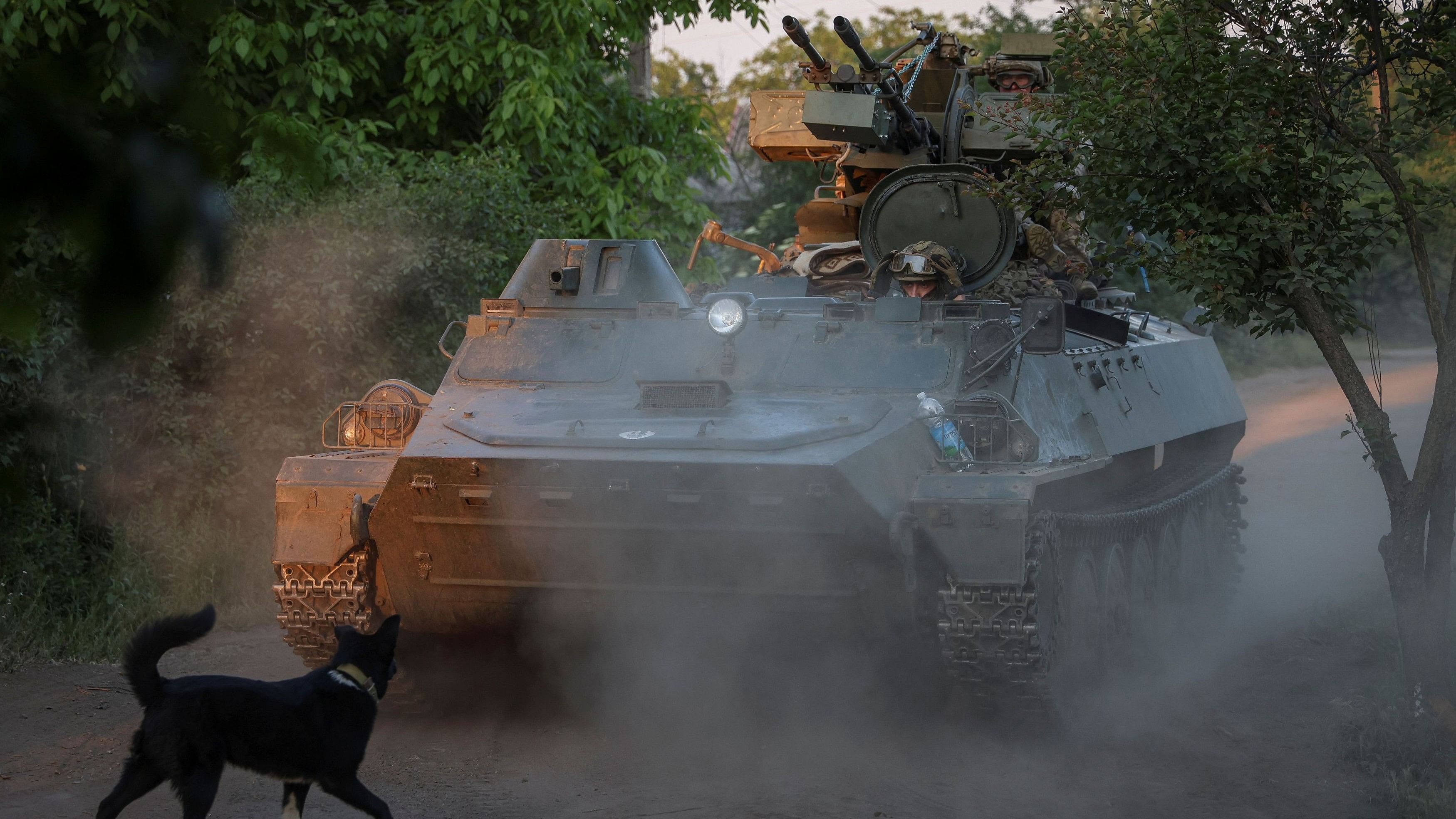 <div class="paragraphs"><p>A Ukrainian serviceman rides an APC at a frontline near the town of Bakhmut</p></div>