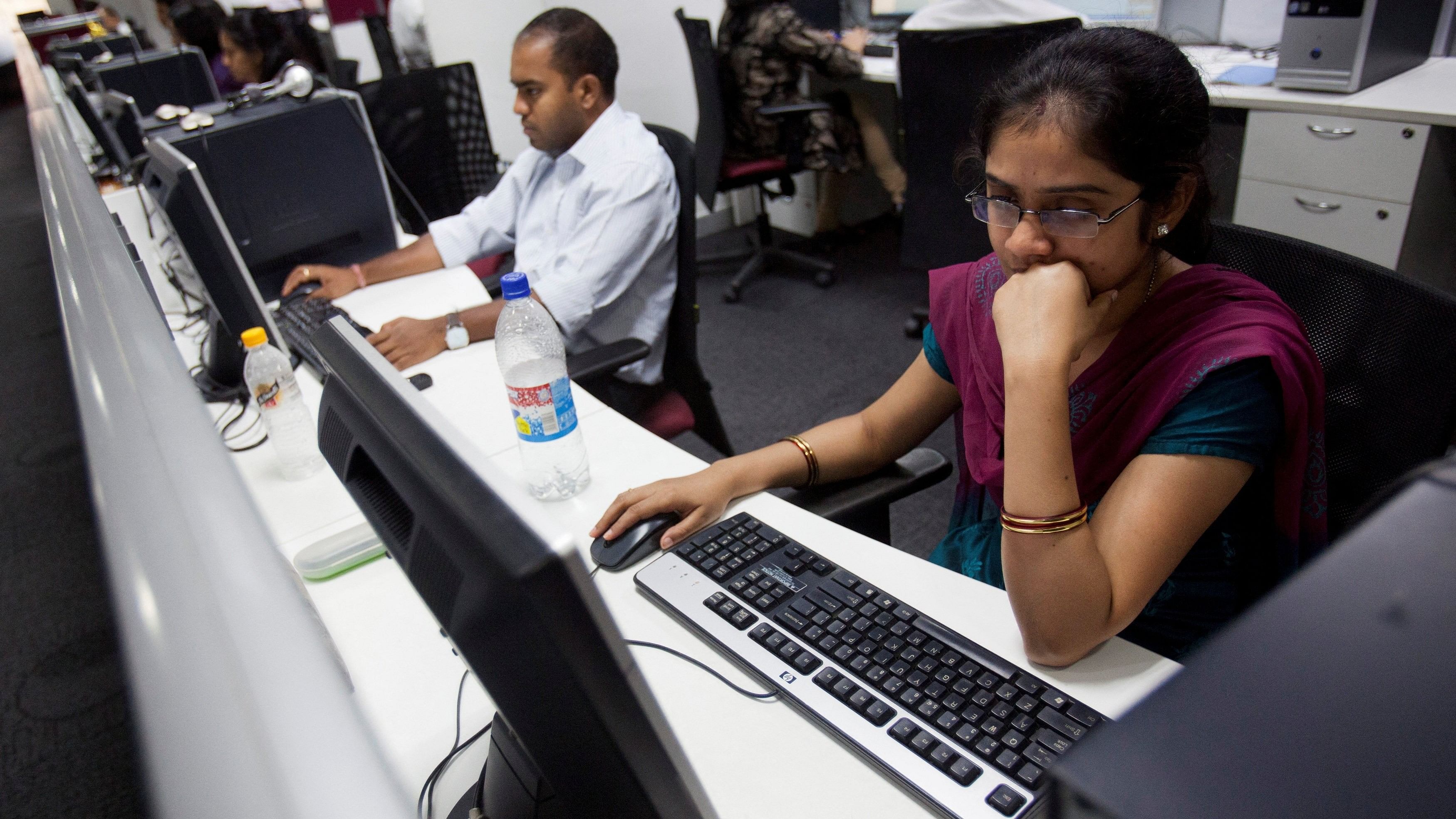 <div class="paragraphs"><p>Workers are seen at their workstations on the floor of an outsourcing centre in Bangalore.</p></div>