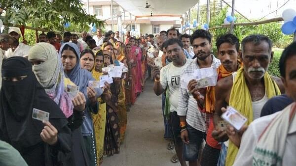 <div class="paragraphs"><p>Voters show their ID cards as they wait to cast their votes for the fifth phase of Lok Sabha elections, in Hajipur, Monday.</p></div>