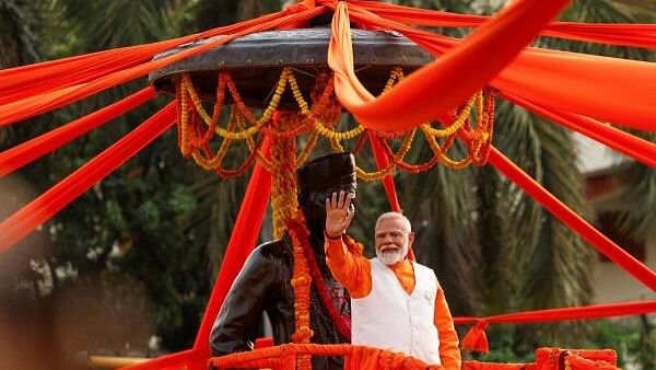 <div class="paragraphs"><p>Prime Minister Narendra Modi waves towards his supporters during a roadshow as part of an election campaign, in Varanasi, India, May 13, 2024.</p></div>