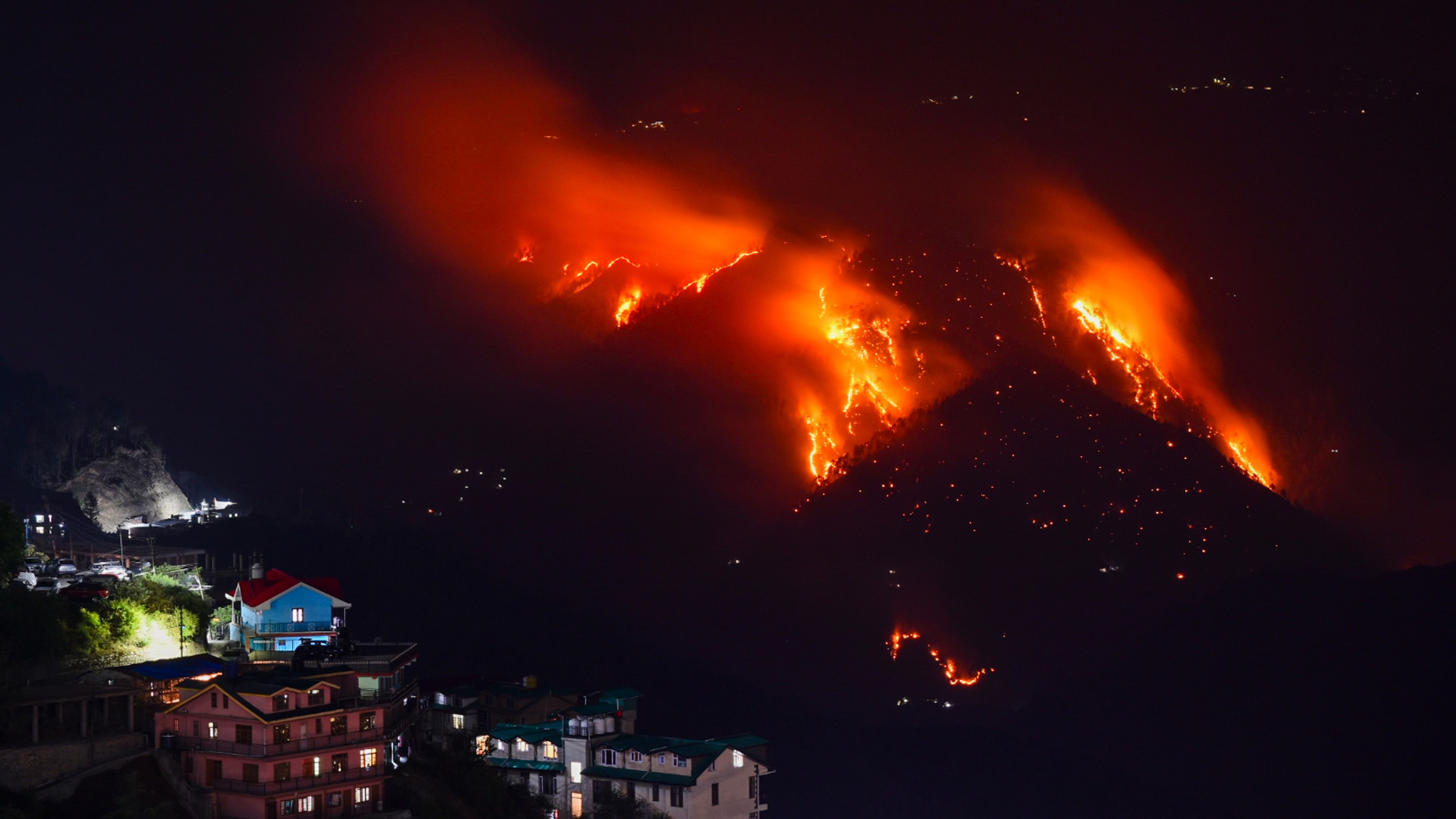 <div class="paragraphs"><p>Flames billow out after a fire broke out in a forest near residential area, in Shimla, on Sunday.</p></div>