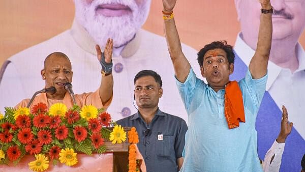 <div class="paragraphs"><p>Uttar Pradesh Chief Minister Yogi Adityanath with BJP candidate Ravi Kishan during a public meeting for Lok Sabha polls, in Gorakhpur, Tuesday.</p></div>