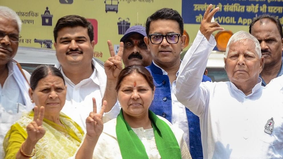 <div class="paragraphs"><p>RJD chief Lalu Prasad Yadav(R) with wife Rabri Devi(L) and daughter and party candidate from Patliputra constituency Misa Bharti(C) shows victory sign after Bharti filed her nomination papers for Lok Sabha elections, in Patna.</p></div>