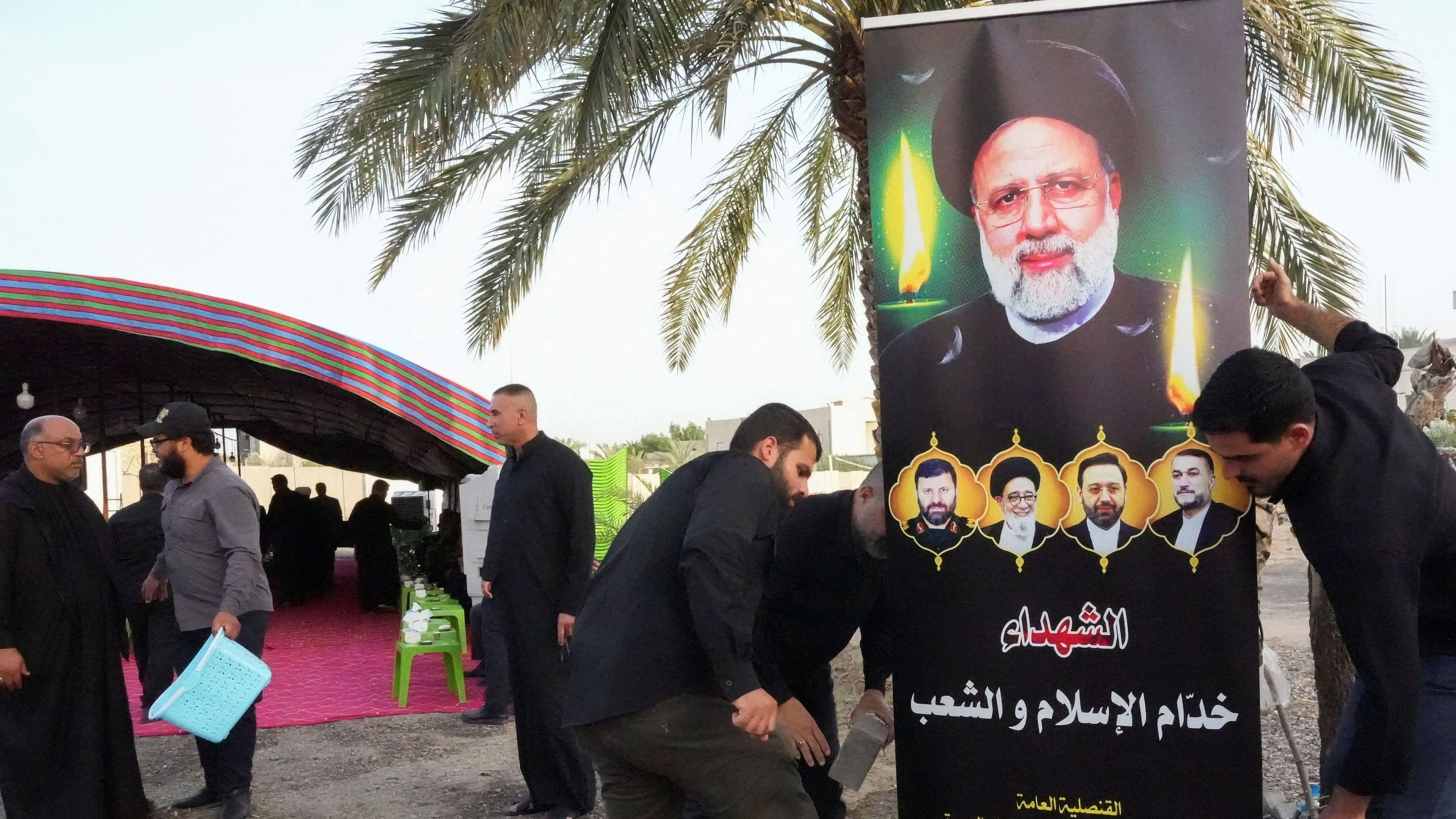 <div class="paragraphs"><p>People puts a poster of late Iran's President Ebrahim Raisi inside the Iranian consulate after his death, in Basra, Iraq May 20, 2024. </p></div>