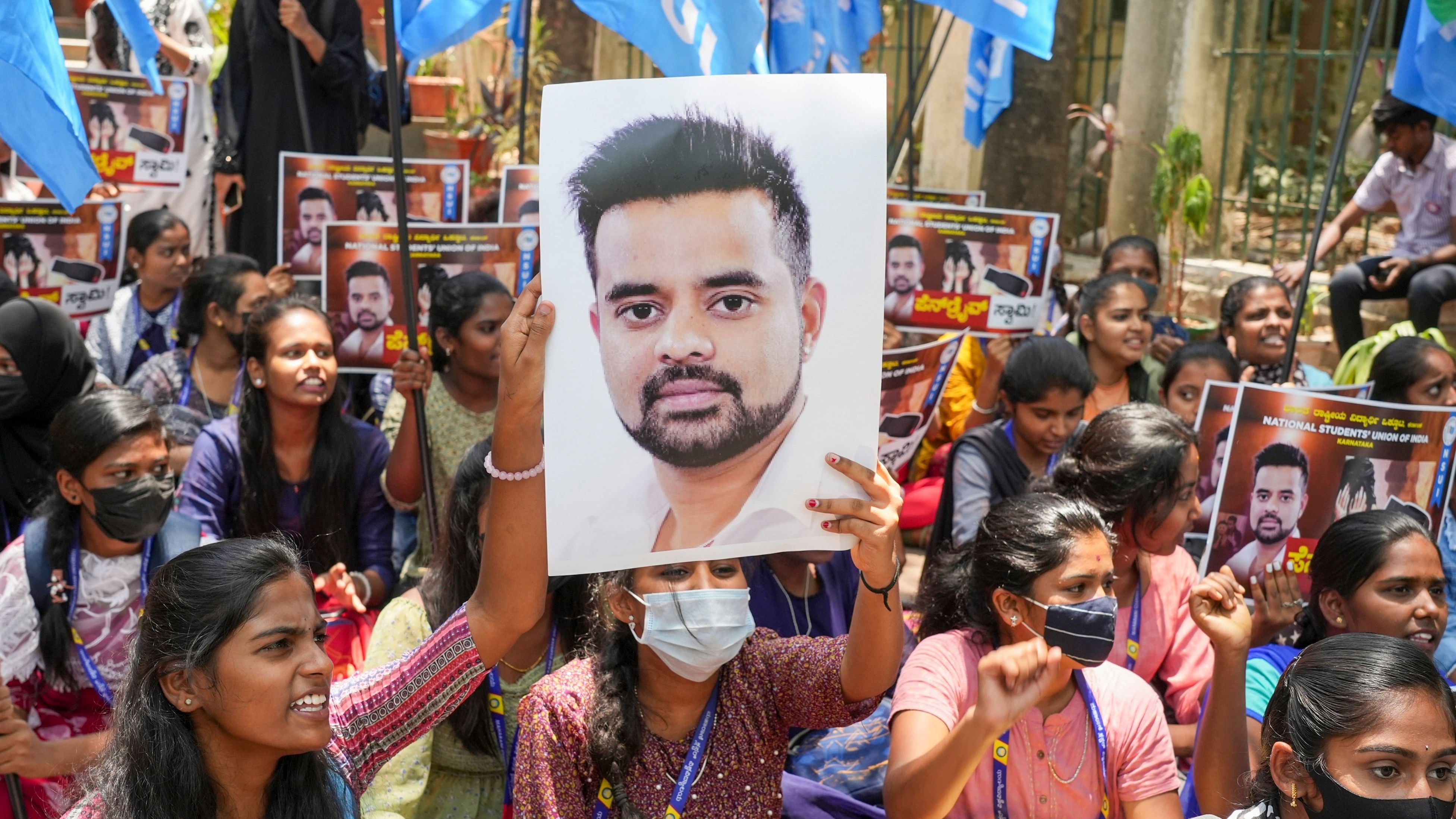<div class="paragraphs"><p>Women protesting with picture of Prajwal Revanna.</p></div>