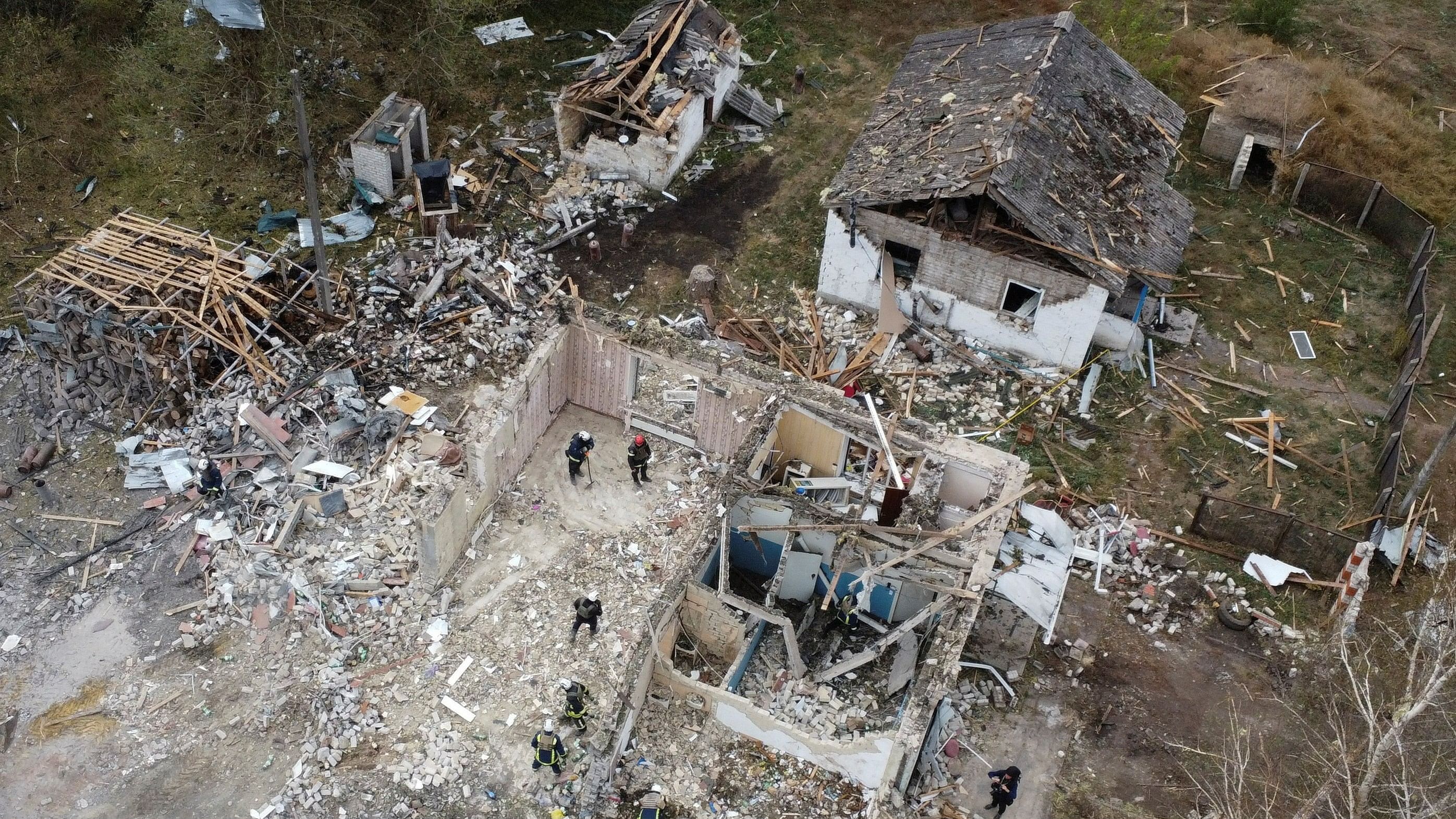 <div class="paragraphs"><p>Rescues remove debris at a site of buildings of a local cafe and a grocery store, where at least 52 people were killed by a Russian missile strike, amid Russia's attack on Ukraine, in the village of Hroza, in Kharkiv region, Ukraine October 6, 2023. </p></div>