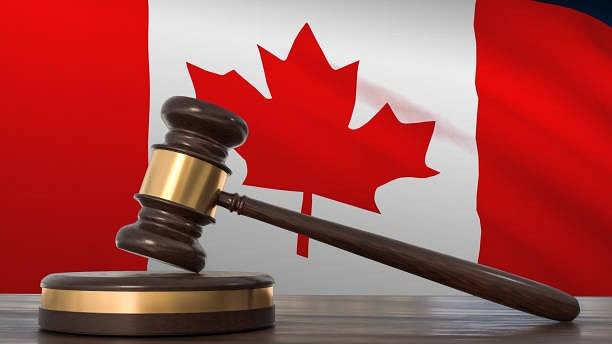 <div class="paragraphs"><p>Wooden gavel with Canada's flag appearing in the background.</p></div>