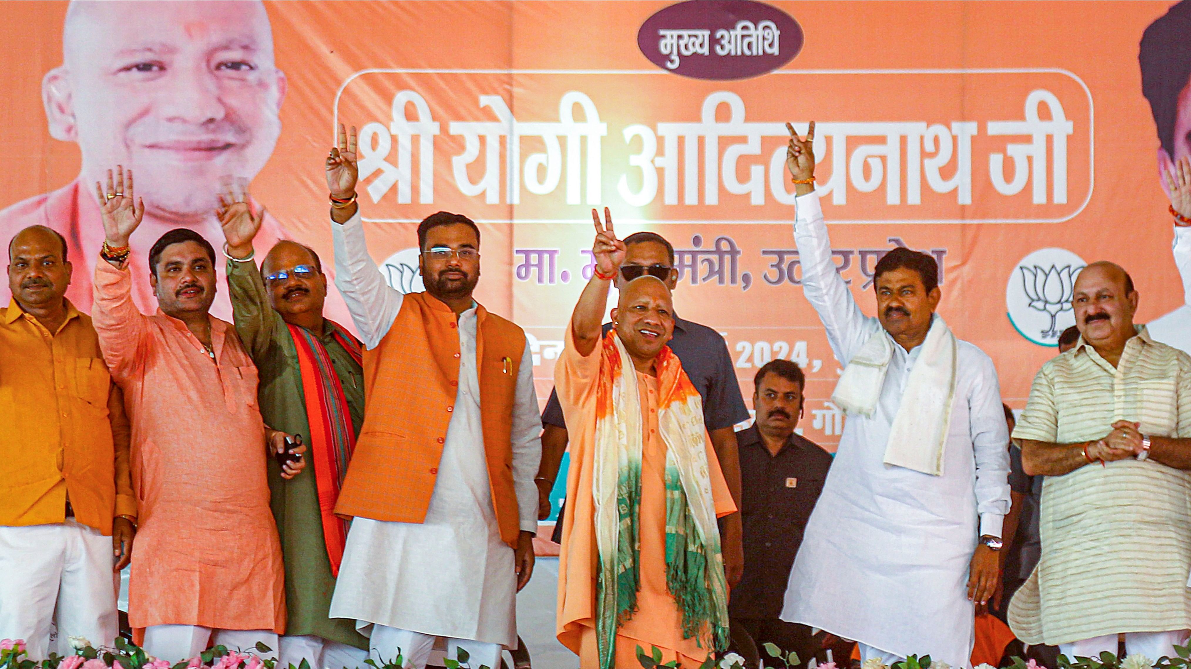 <div class="paragraphs"><p>Uttar Pradesh Chief Minister Yogi Adityanath waves to supporters during a public meeting in support of BJP candidate Ajay Mishra Teni for the Lok Sabha elections, in Lakhimpur Kheri district, Thursday, May 9, 2024.</p></div>