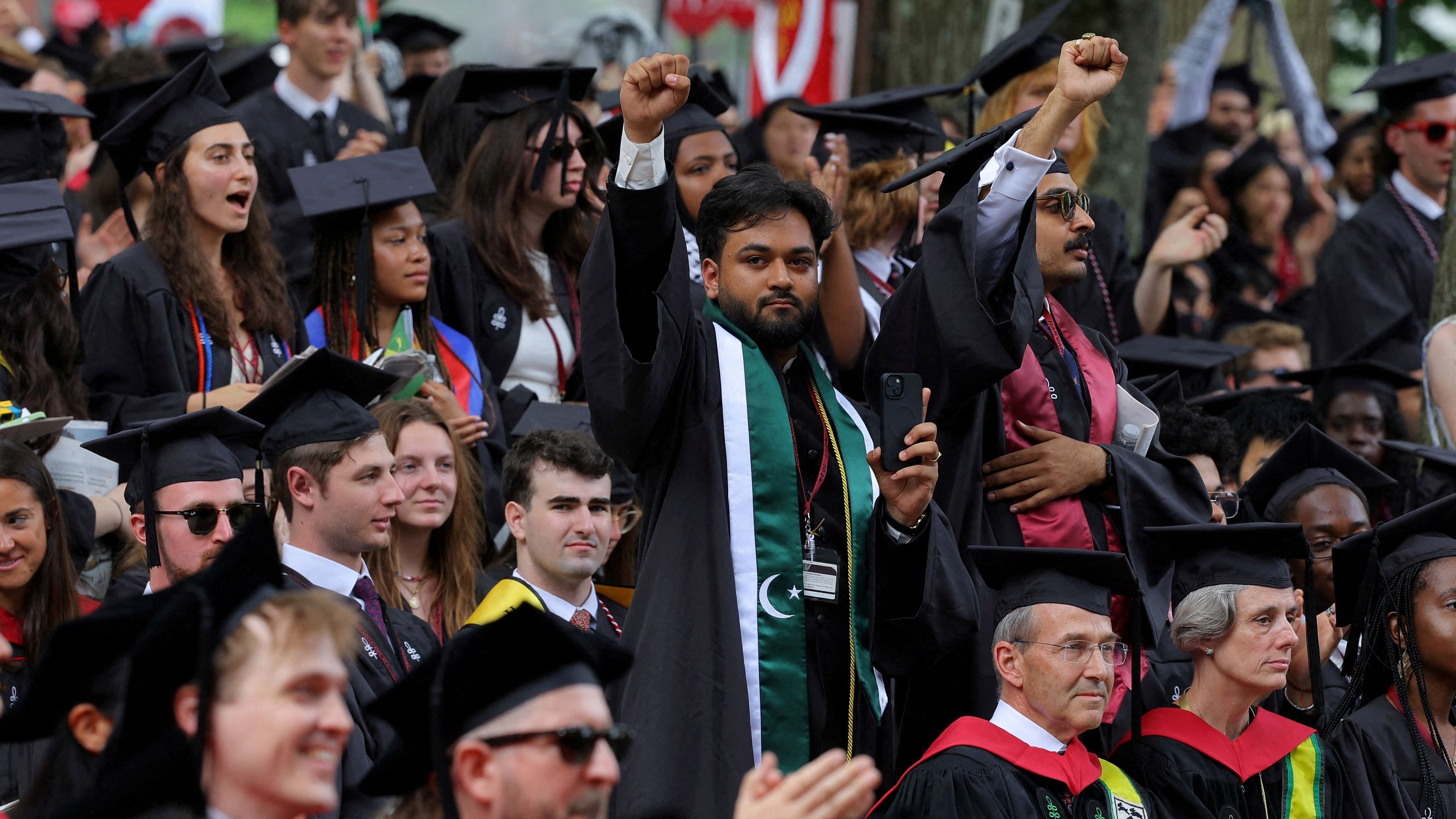 <div class="paragraphs"><p>One of 13 students not able to graduate because they participated in pro-Palestinian protests raises his fist during the 373rd Commencement Exercises at Harvard University, amid the ongoing conflict between Israel and the Palestinian Islamist group Hamas, in Cambridge, Massachusetts, US, May 23, 2024.</p></div>