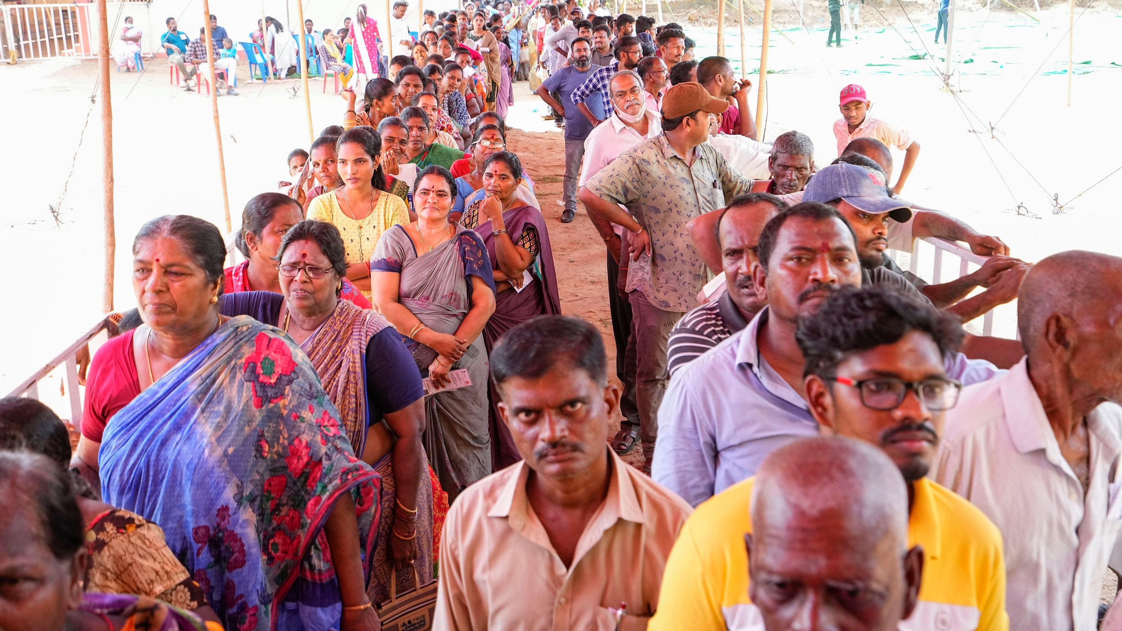 <div class="paragraphs"><p>People wait in queues to cast their votes at a polling station during the elections.</p></div>