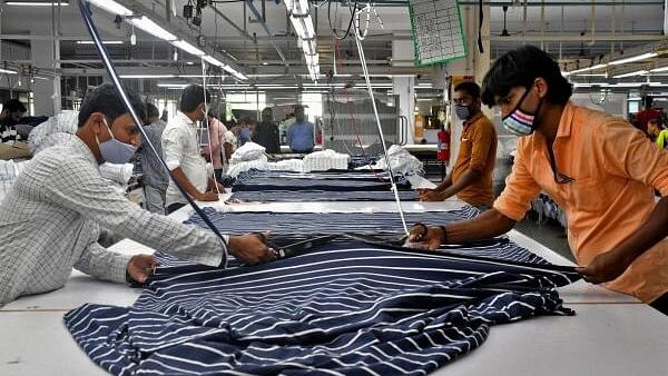 <div class="paragraphs"><p>Garment workers cut fabric to make shirts at a textile factory of Texport Industries in Hindupur.</p></div>