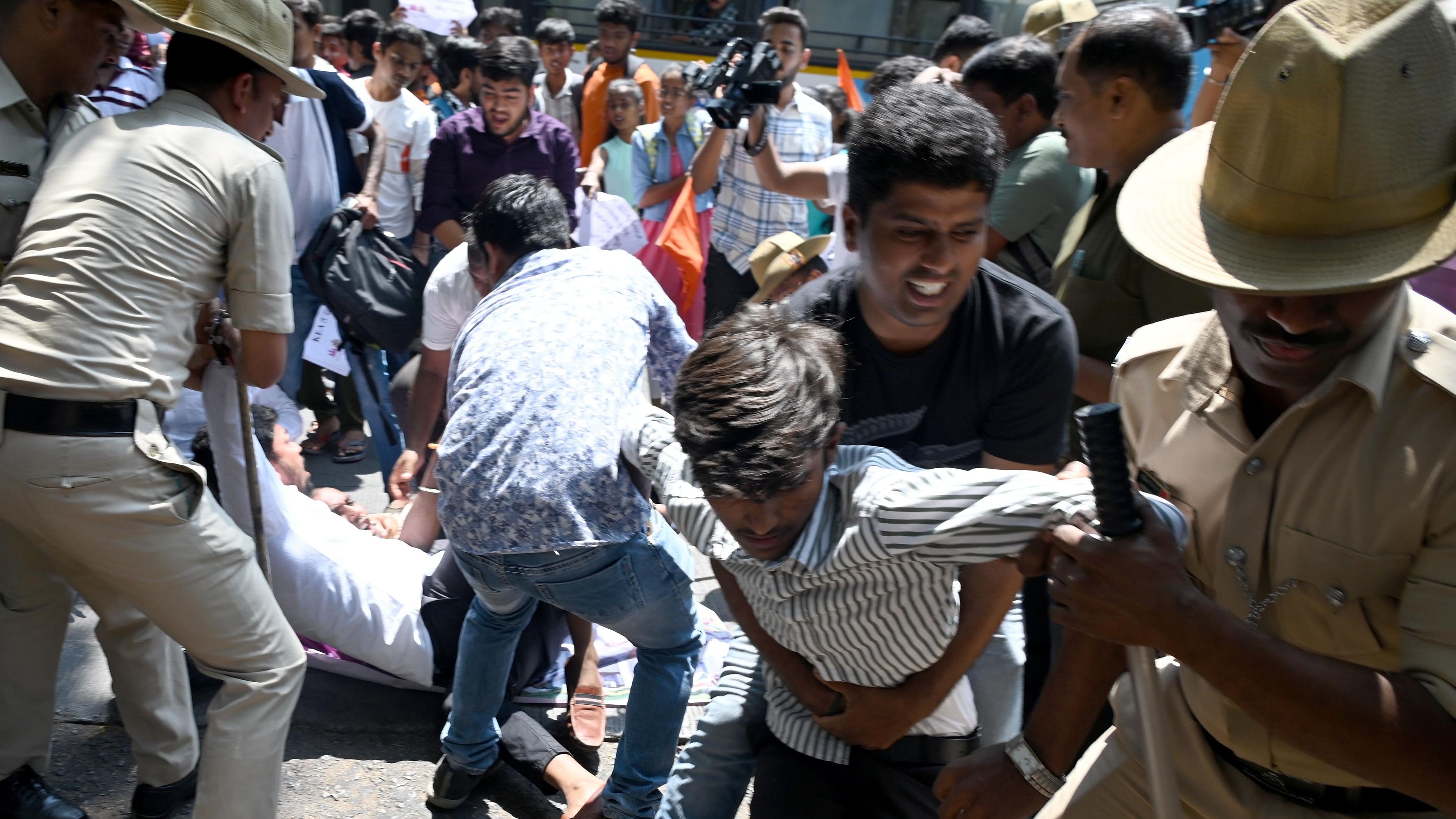 <div class="paragraphs"><p>Police detained members of Akhil Bharatiya Vidyarthi Parishad (ABVP) during their protest against problems in KCET 2024 exam conducted by KEA admissions authority, in front of CET cell in Bengaluru.</p></div>