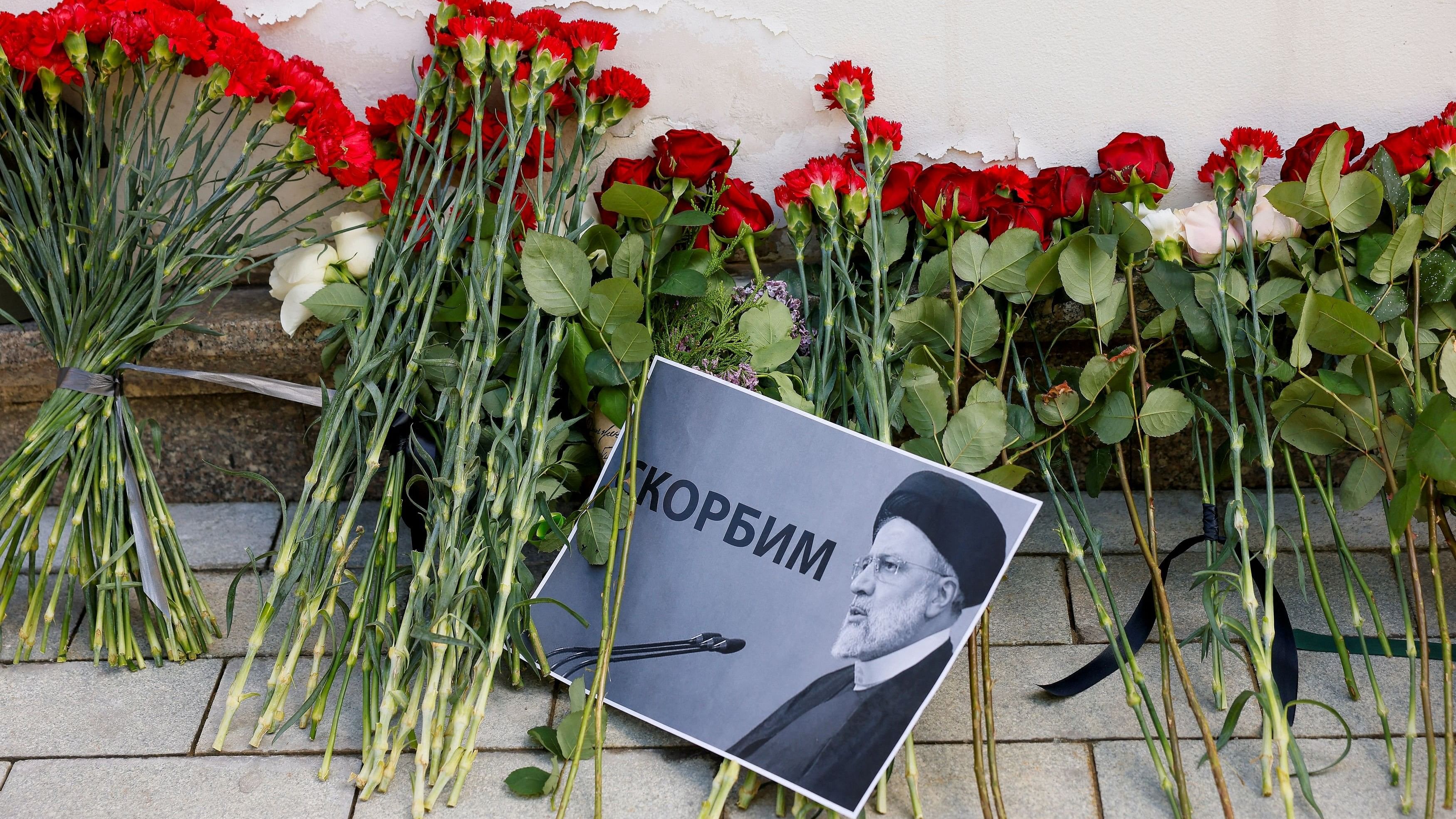 <div class="paragraphs"><p>A view shows flowers outside the Iranian embassy placed to pay tribute to Iran's President Ebrahim Raisi, Foreign Minister Hossein Amirabdollahian and other victims of a recent helicopter crash in mountainous terrain near Iran's border with Azerbaijan, in Moscow, Russia, May 20, 2024. A placard with a portrait of Iran's President Ebrahim Raisi reads: "We mourn". </p></div>