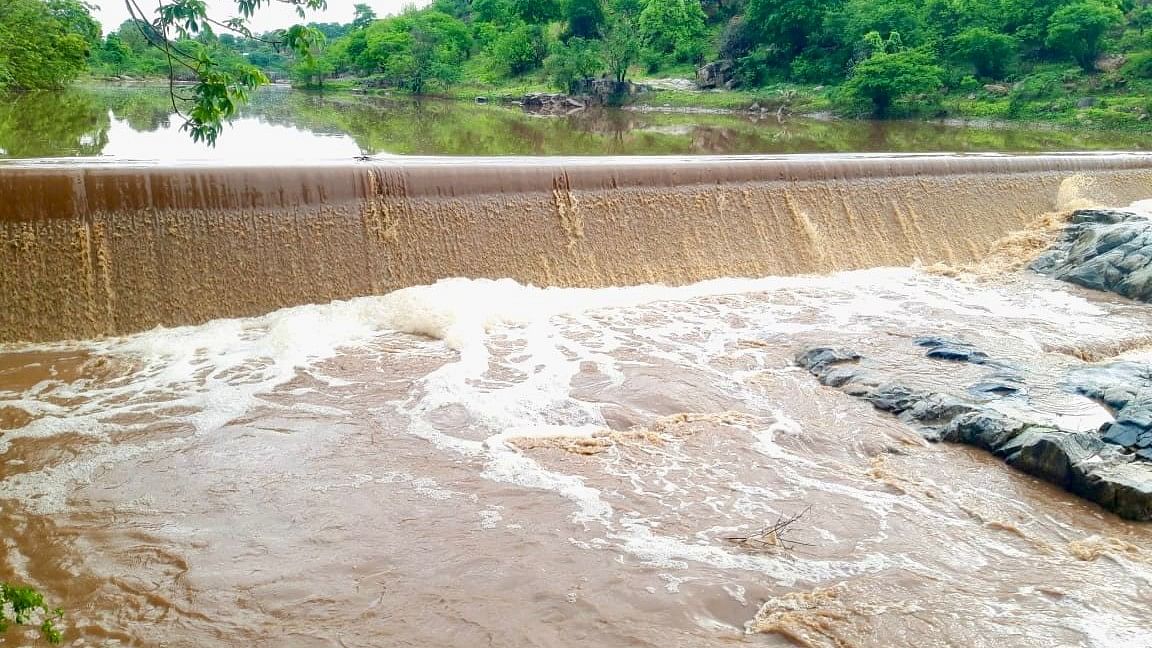 A check dam breaches following heavy rain, in Sandanapalya village of Hanur taluk in Chamarajanagar district on Thursday. 