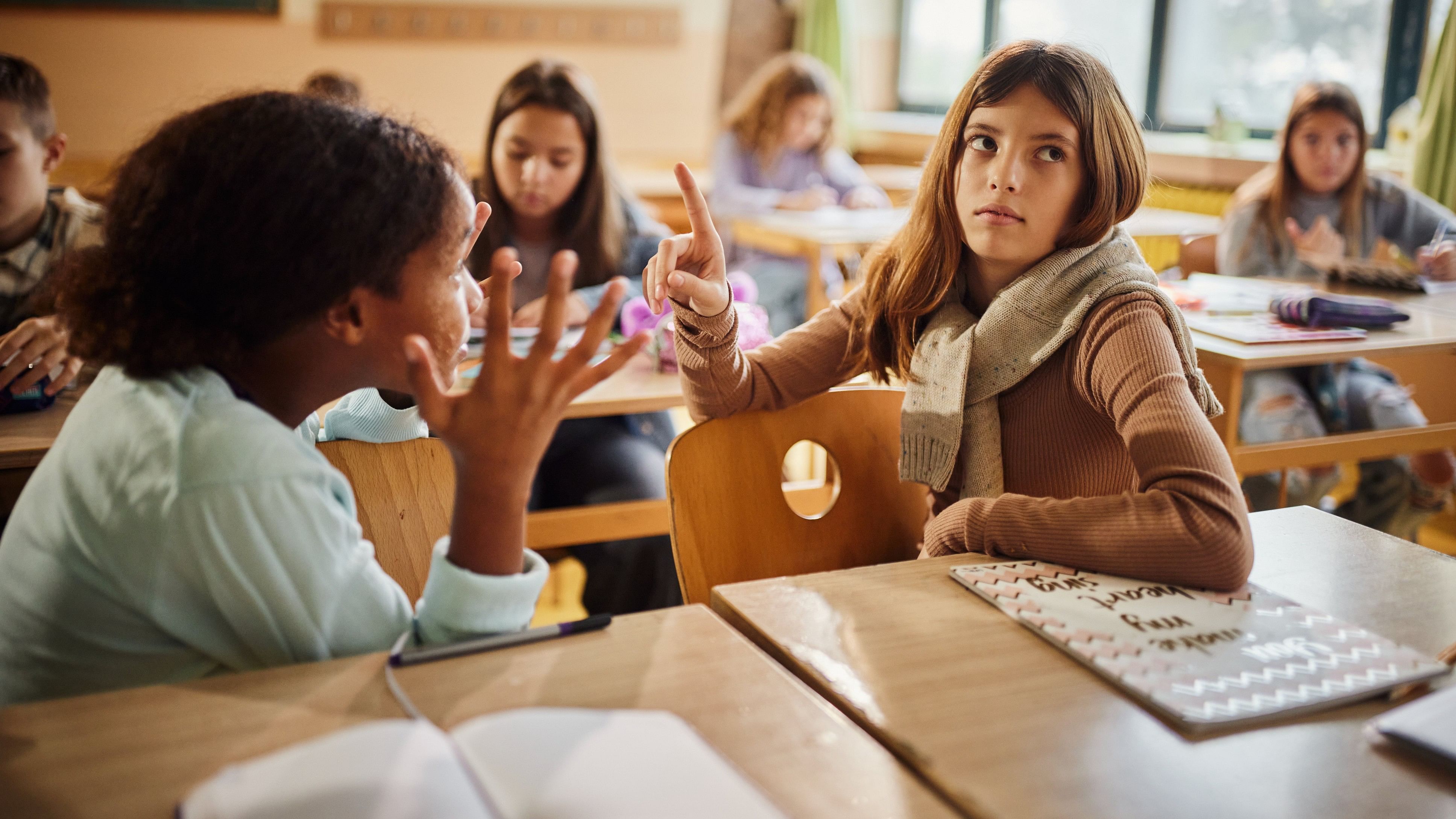 Elementary student ignoring her friend during an argument in the classroom.