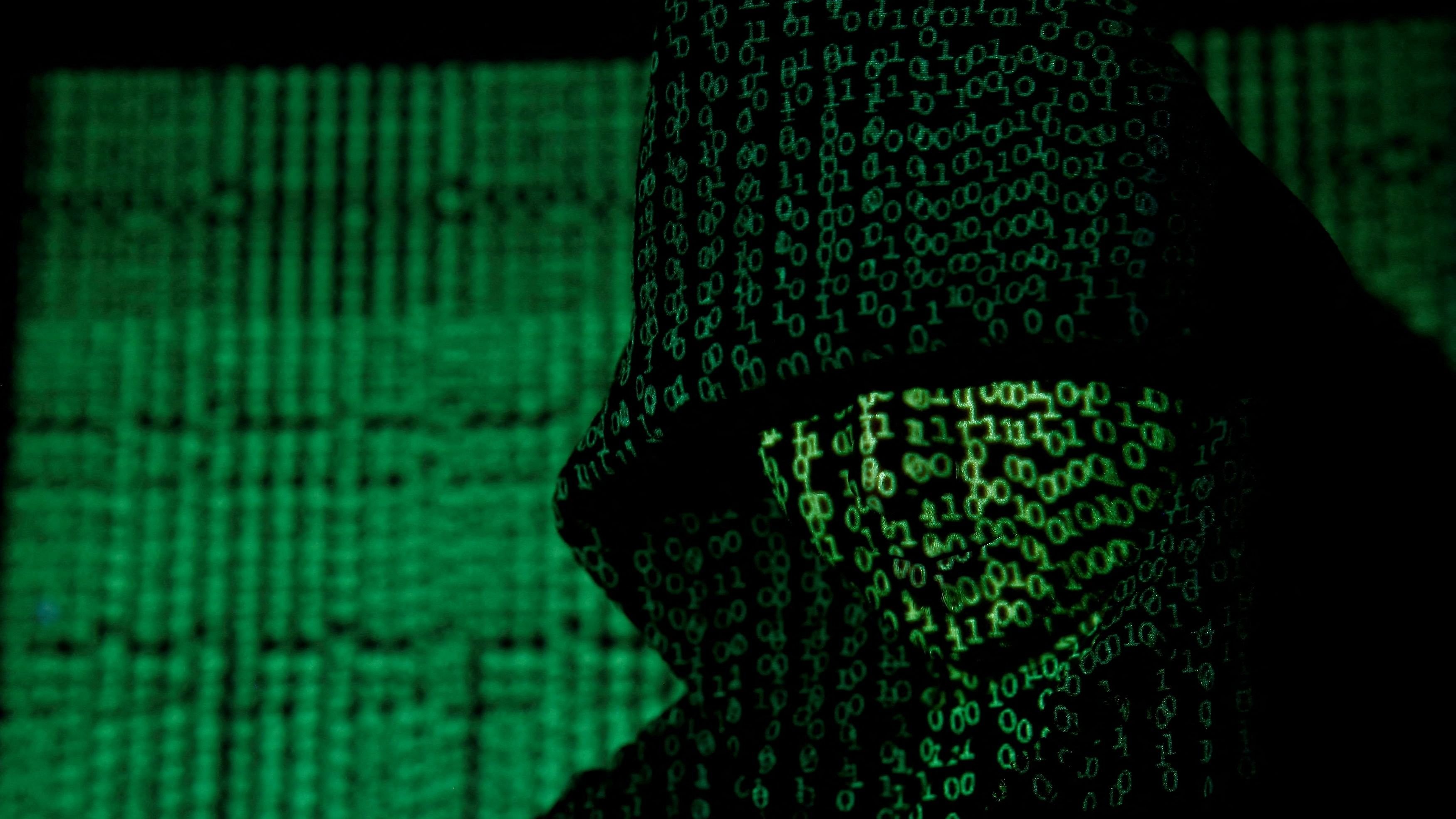 <div class="paragraphs"><p>FILE PHOTO: A projection of cyber code on a hooded man is pictured in this illustration picture taken on May 13,  2017. Capitalizing on spying tools believed to have been developed by the U.S. National Security Agency, hackers staged a cyber assault with self-spreading malware that has infected tens of thousands of computers in nearly 100 countries.</p></div>