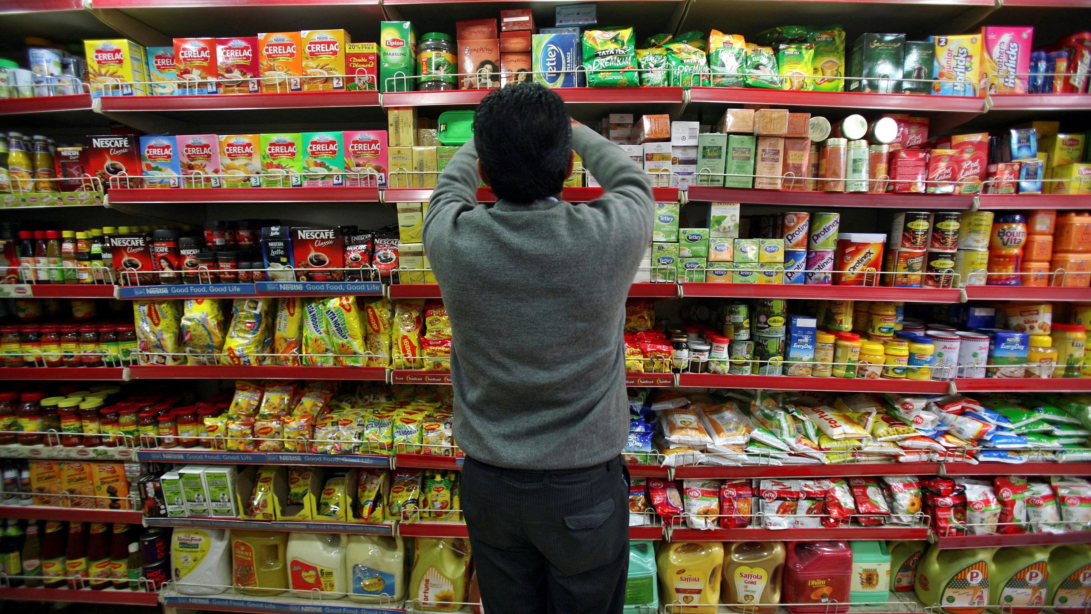 <div class="paragraphs"><p> A worker arranges consumable goods at a grocery store.</p></div>