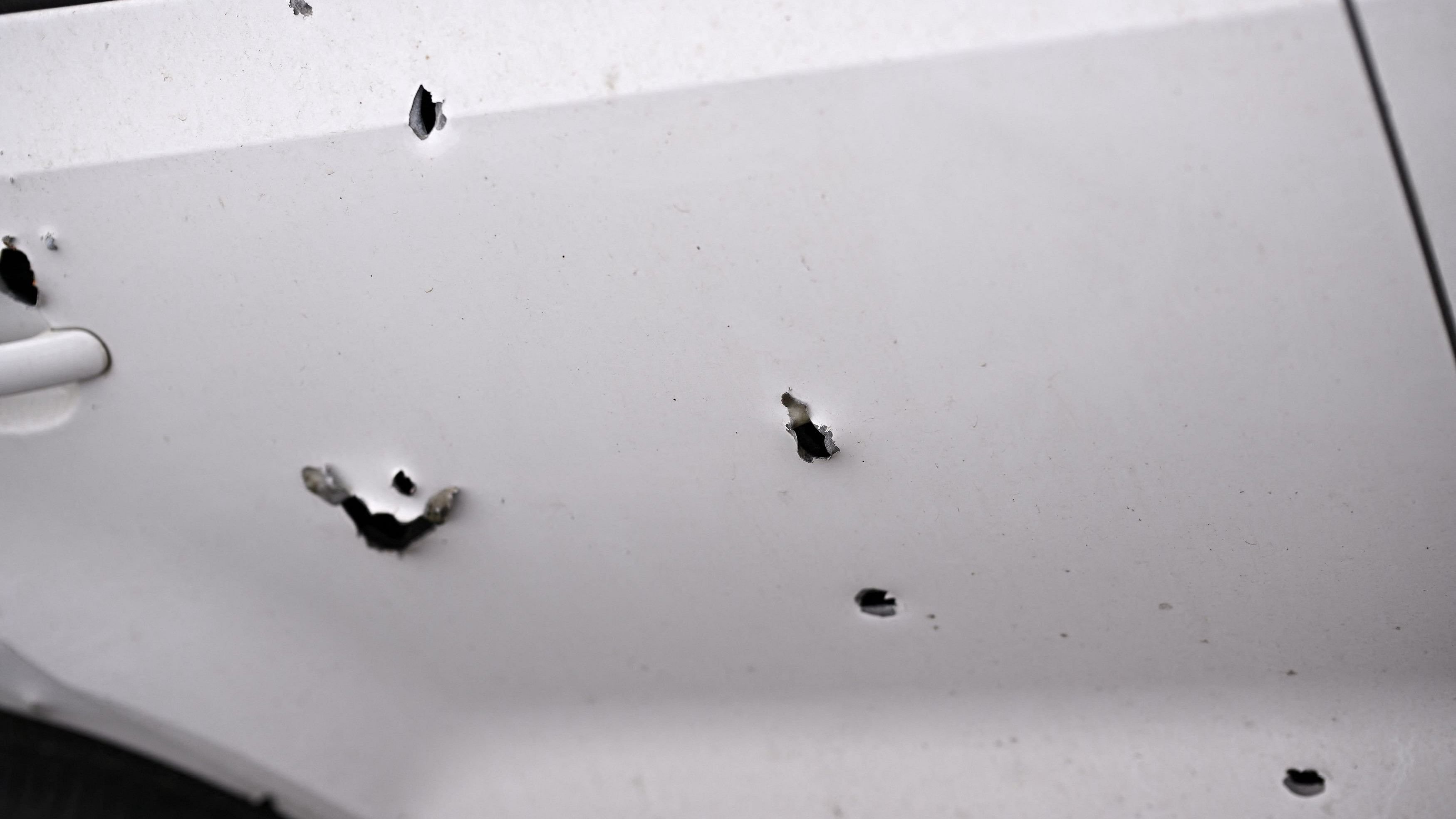 <div class="paragraphs"><p>Representative image showing bullet holes on a car.</p></div>