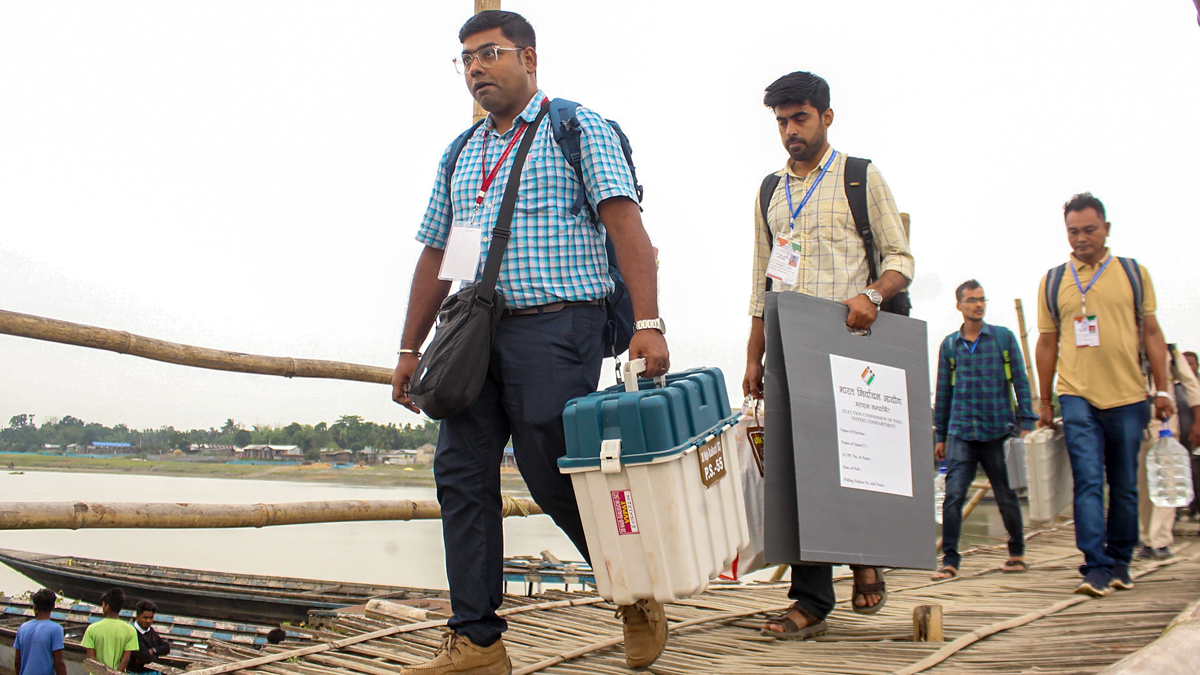 <div class="paragraphs"><p>Election officials carry EVMs and other election materials to their respective polling booths on the eve of 3rd phase of voting for Lok Sabha elections, at Hajo block of Kamrup district, Monday.</p></div>