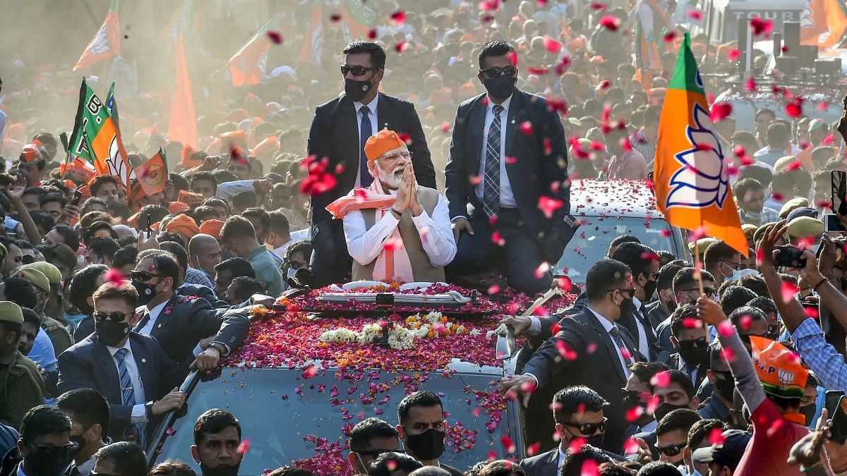 <div class="paragraphs"><p>Prime Minister Narendra Modi greets supporters during a roadshow for the seventh and last phase of UP Assembly elections, in Varanasi district,</p></div>