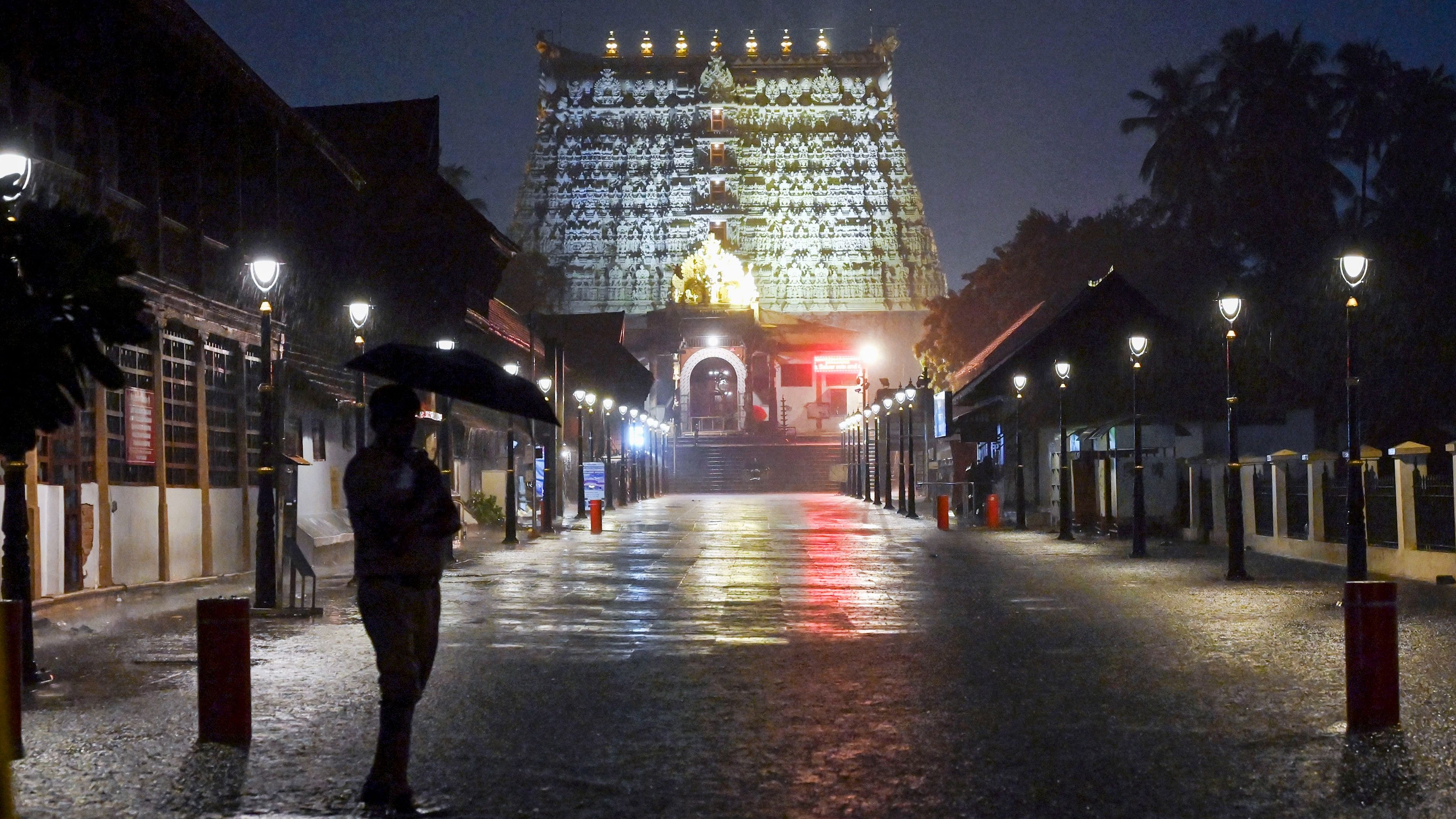 <div class="paragraphs"><p>A security personnel stands guard in front of the Sree Padmanabhaswamy temple amid rain, in Thiruvananthapuram, Saturday.</p></div>