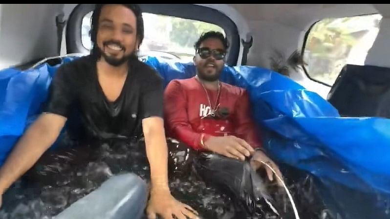 <div class="paragraphs"><p>Vlogger 'Sanju Techy' with his friends in the makeshift 'pool' in the car.</p></div>