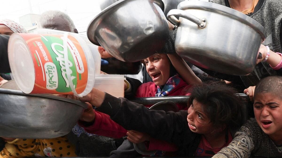 <div class="paragraphs"><p>Palestinian children wait to receive food cooked by a charity kitchen amid shortages of food supplies.</p></div>