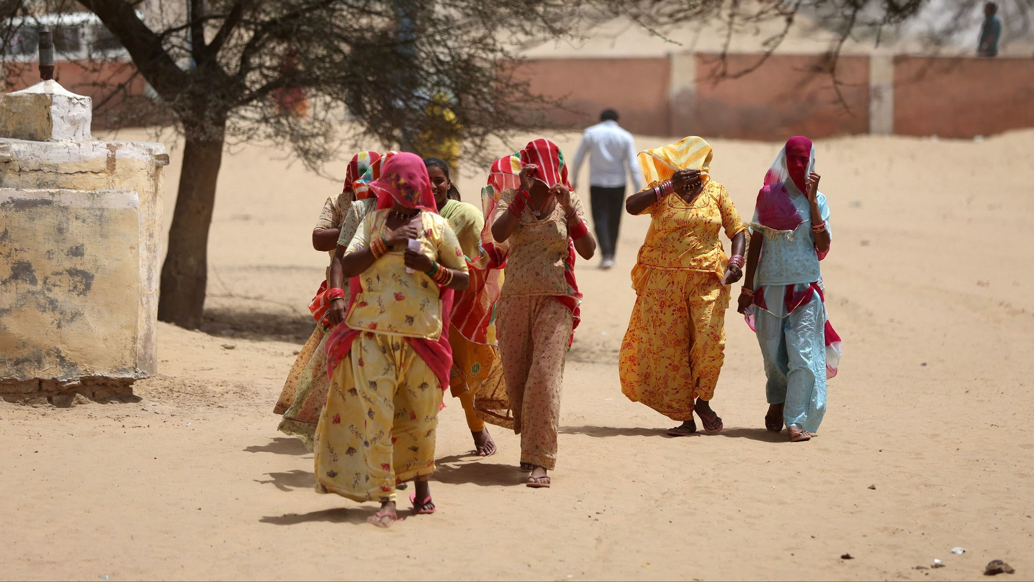 <div class="paragraphs"><p>Women cover their faces to protect from heat as they arrive at a polling station to cast their votes during the first phase of the Lok Sabha Election, in Bikaner, Rajasthan, April 19, 2024. </p></div>