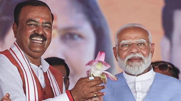 <div class="paragraphs"><p>Prime Minister Narendra Modi being felicitated by Uttar Pradesh Deputy Chief Minister Keshav Prasad Maurya during a public meeting for the Lok Sabha elections, in Fatehpur district, Friday, May 17, 2024.</p></div>