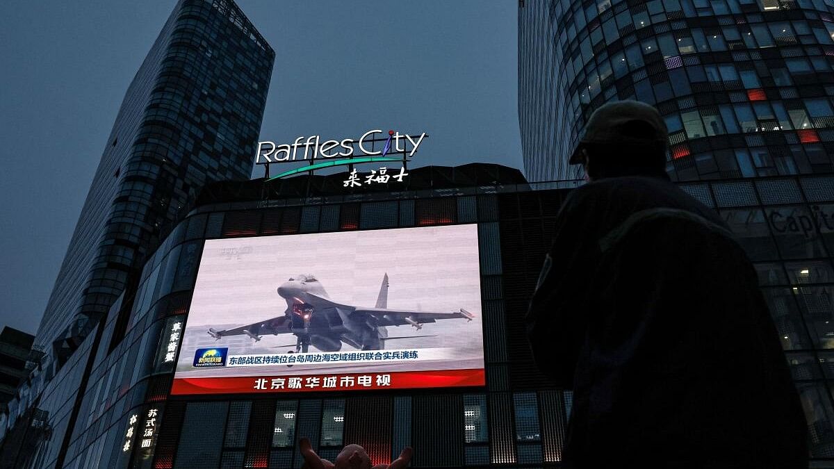 <div class="paragraphs"><p>A screen shows news footage of military drills conducted in areas around the island of Taiwan by the Eastern Theatre Command of the PLA in Beijing.</p></div>